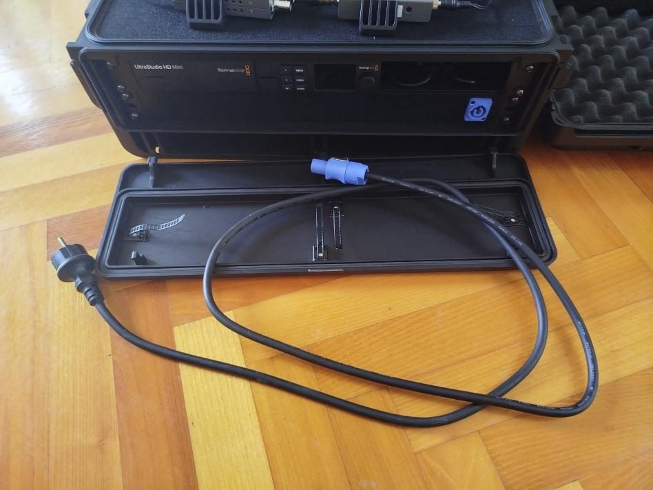 Detachable powerCON mains lead beside the rack