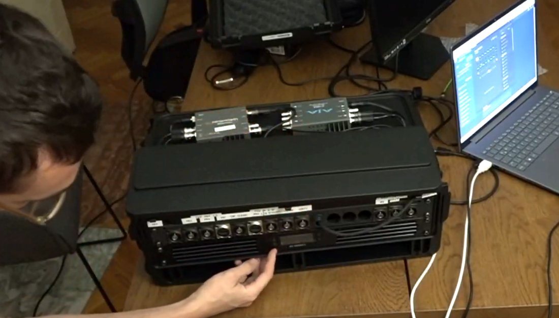 Hand adjusting the fan control panel on the front of the TVG rack