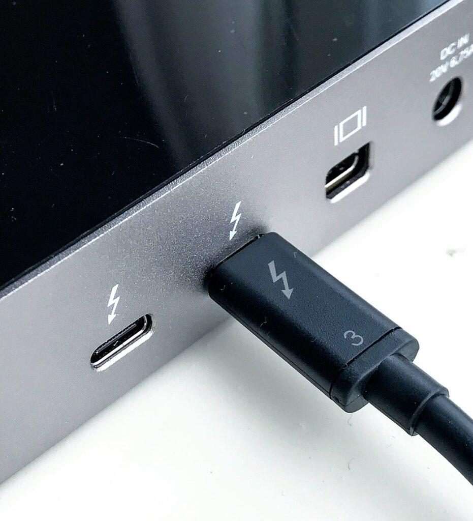 Laptop side showing Thunderbolt ports marked with a lightning symbol