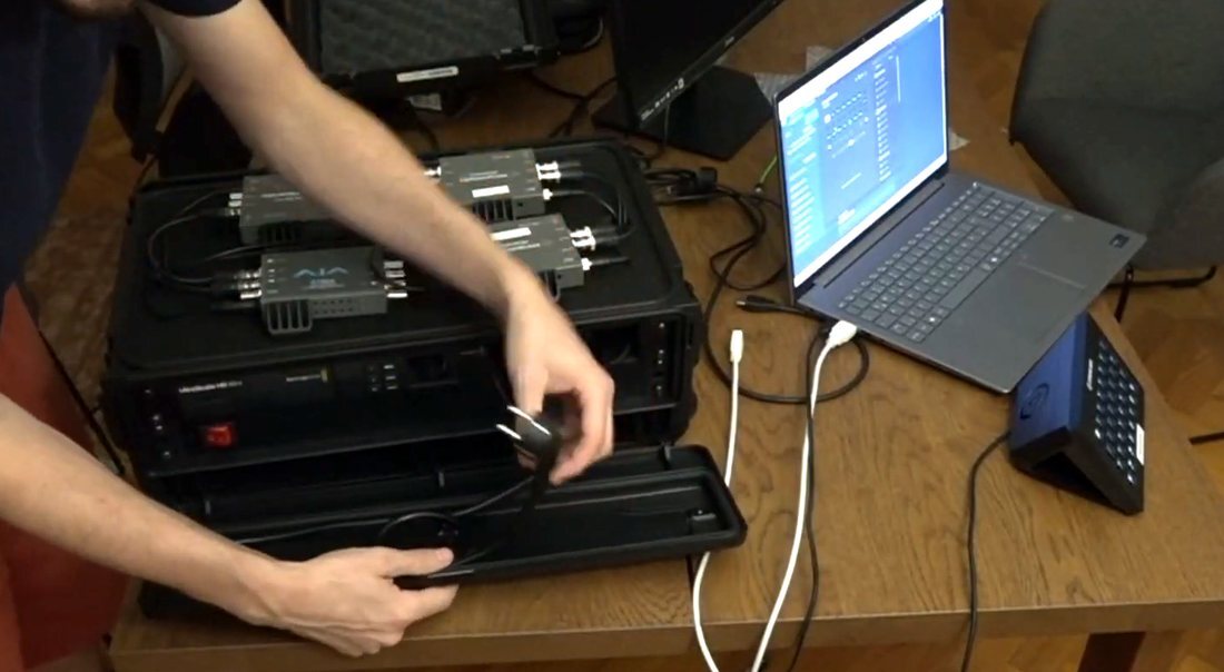 Hands refitting the side panel on the power side of the rack